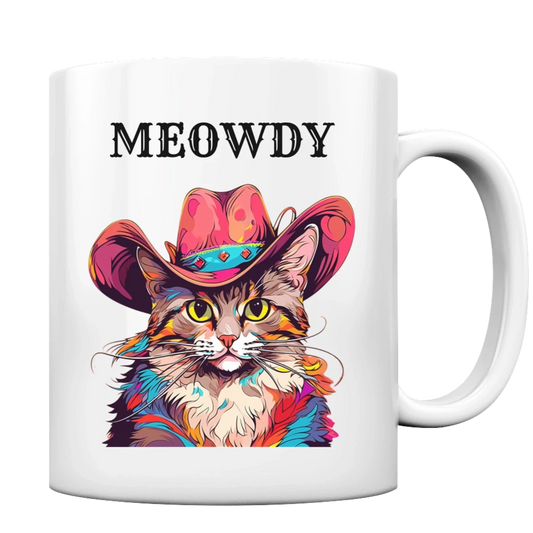 Weiße Tasse mit Henkel. Motiv: Katze, in auffällig bunter Fellfarbe (Pop-Art-Stil), die einen Cowboy-Hut trägt. Darüber der Schriftzug "Meowdy"
